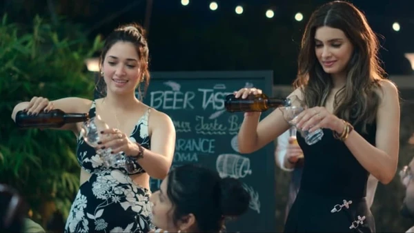 Two friends pour beer at an event in the series "Do You Wanna Partner".