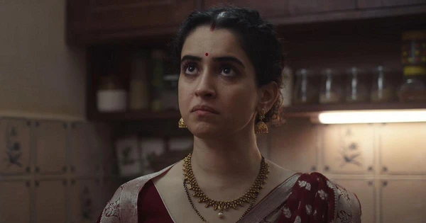 A woman looks pensive in a kitchen in the movie "Mrs".