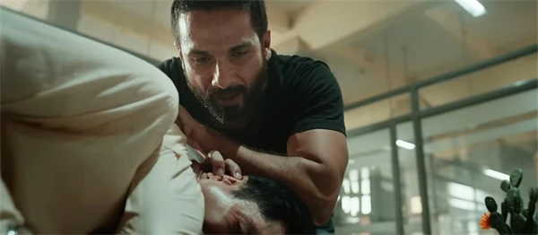 Deva appears to be interrogating a suspect in a tense scene from the movie "Deva".
